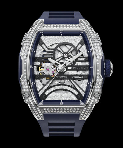 Close-up front view of open dial watch with diamond-set silver case and navy blue strap, shown on transparent background.