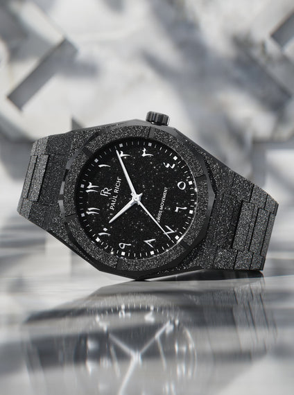 Paul Rich black frosted watch with black aventurine dial, silver Eastern Arabic numerals, and Swiss movement on black bracelet.