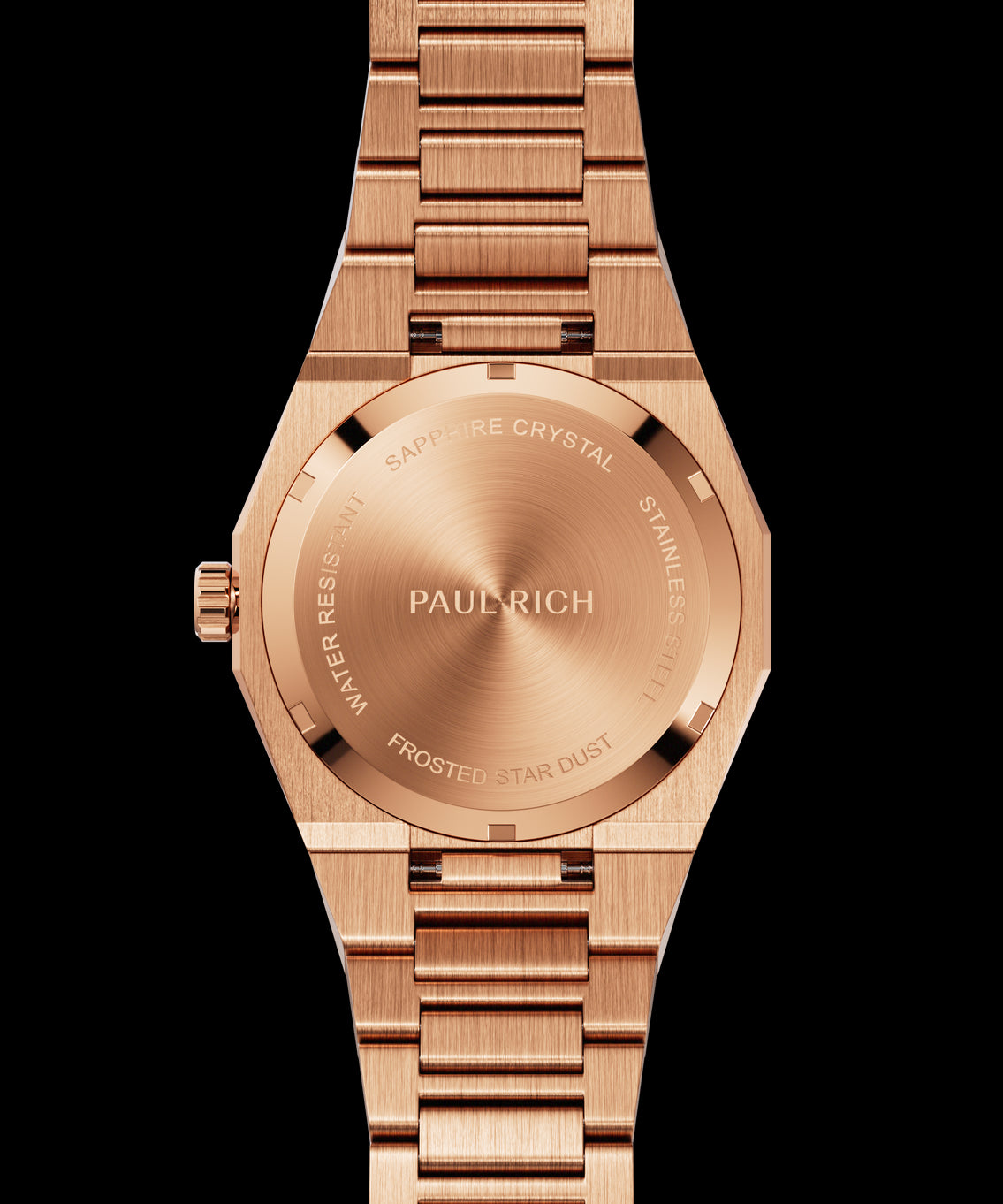 Rose gold frosted watch case back with circular brushed finish and engraved markings for sapphire crystal, water resistance, and model name.