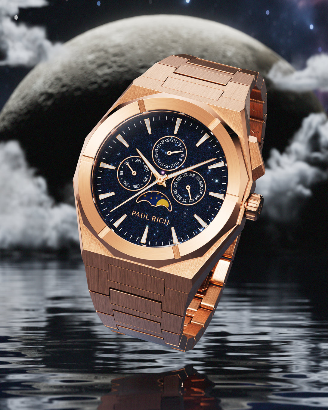 Brushed rose gold stainless steel watch with blue aventurine dial, moonphase, and subdials, set against a moonlit sky with clouds over water.