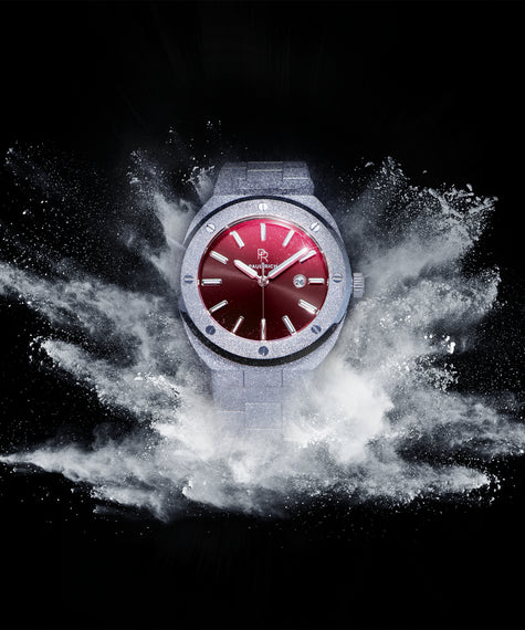 Paul Rich Frosted Pashas watch with a ruby-red dial and full frosted finish, exploding on a black background.