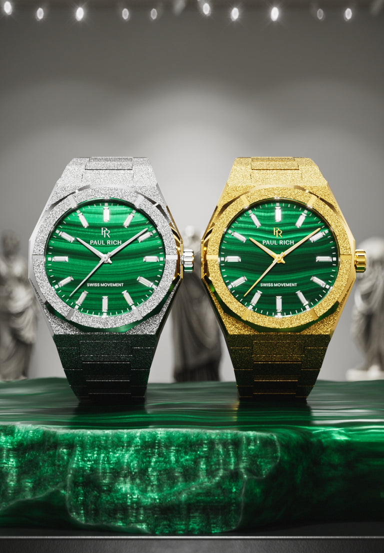 Silver and gold Malachite Aurora watches with green malachite dials, on a malachite stone in a gallery